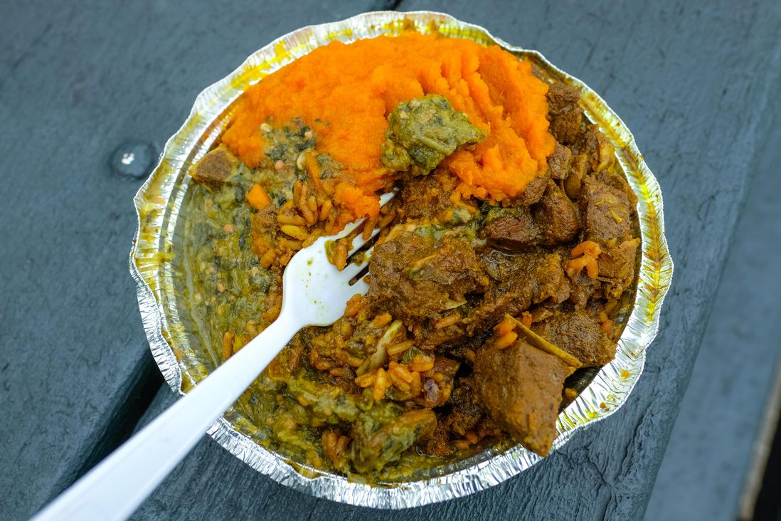 Curry Goat on Peas and Rice with Pumpkin and Callaloo ($13.50)